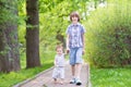 Brother and baby sister walking in the park