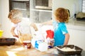 Brother, baking and flour with children fighting in the kitchen while making a mess of their home together. Cooking