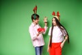 Brother boy and girl are smiling and excited and open red gift box on green Royalty Free Stock Photo