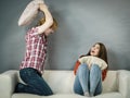 Man and woman having pillow fight.