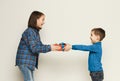 Brother giving his sister gift, white studio Royalty Free Stock Photo