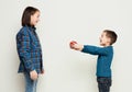 Brother giving his sister gift, white studio Royalty Free Stock Photo