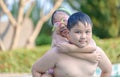 Brother holding his sister on his back in swimming pool Royalty Free Stock Photo