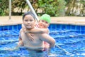 Brother holding sister on his back in swimming pool Royalty Free Stock Photo