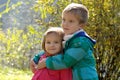 Brother hugging sister in autumn park Royalty Free Stock Photo