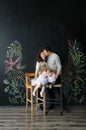 The brother kisses the sister. Mother kisses the father. Portrait of members of the family in studio. Royalty Free Stock Photo