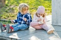 Brother look at sister touch nose with sport shoe outdoor Royalty Free Stock Photo