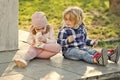 Brother look at sister touch nose with sport shoe outdoor Royalty Free Stock Photo