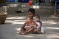 Brother looks after younger sister in Bagan