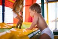 Brother and older sister are playing in the playroom and jumping on a trampoline on a summer day Royalty Free Stock Photo