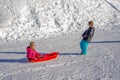 Brother pulling his sister kids toboggan sled snow. Little girl and boy enjoying sleigh ride. Child sledding. Children Royalty Free Stock Photo