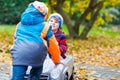 Brother pushing car for child. Happiness, fun, leisure in fall park. Royalty Free Stock Photo