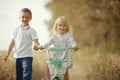 Brother and sister on autumn road Royalty Free Stock Photo