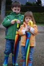 Brother and sister and big umbrellas Royalty Free Stock Photo