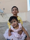 Brother and sister bonding, affection, sitting on the floor, Royalty Free Stock Photo