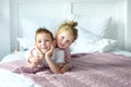 Brother and sister boy and girl play together in bedroom. Little girl lay on her brother back. Happy childhood in cozy family Royalty Free Stock Photo