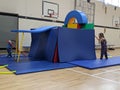 Brother and sister building a base fort out of mats and sticks Royalty Free Stock Photo