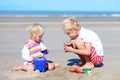 Brother and sister building sand castles on the beach Royalty Free Stock Photo