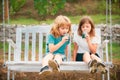 Brother and sister drink green smoothie outside. Little boy and girl working in the garden. Two happy children in summer Royalty Free Stock Photo