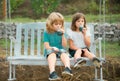 Brother and sister drink smoothie, kids summer cocktail outside. Little boy and girl working in the garden. Two happy Royalty Free Stock Photo