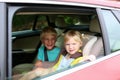 Brother and sister enjoying trip in the car Royalty Free Stock Photo