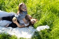 Children are lying and hugging in the grass in the park on a sunny morning.Children look at the camera. Royalty Free Stock Photo