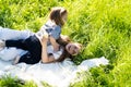 Children are lying and hugging in the grass in the park on a sunny morning.Children look at the camera. Royalty Free Stock Photo