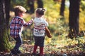 Brother and sister have fun on fresh air. Children play in autumn forest. Little boy and girl friends camping in woods Royalty Free Stock Photo