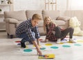 Brother And Sister Having Fun Playing Twister Game On Floor Royalty Free Stock Photo