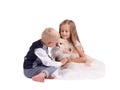 Brother and sister having fun with a puppy isolated on a white background. Kids playing with a dog. Home pet concept.