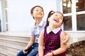 Brother and sister having fun and smiling outdoor together. Happy asian family with their children Royalty Free Stock Photo