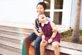 Brother and sister having fun and smiling outdoor together. Happy asian family with their children Royalty Free Stock Photo