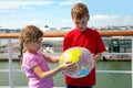 Brother and sister hold inflatable globe