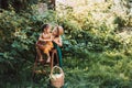 Brother and sister hugging in garden, green and yellow gardener overals, happy family