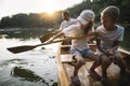 Brother and sister learning to paddle canoe on the lake Royalty Free Stock Photo