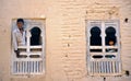 Brother and sister looking outside from their house in Shibam