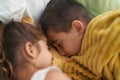 Brother and sister lying on bed sleeping at bedroom Royalty Free Stock Photo