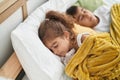 Brother and sister lying on bed sleeping at bedroom Royalty Free Stock Photo