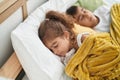 Brother and sister lying on bed sleeping at bedroom Royalty Free Stock Photo