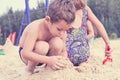 Group of little cute child makes sand castle at the beach Royalty Free Stock Photo