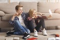 Brother And Sister Making Selfie Gesturing V-Sign Sitting On Floor