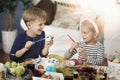 Brother and sister painting Easter eggs Royalty Free Stock Photo