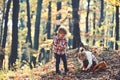 Brother and sister play on fresh air. Kids harvest grass in autumn forest. Small boy and girl friends have fun in woods