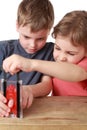 Brother and sister play with little guillotine