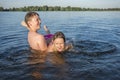 A brother and sister play in the river, on a sunny day.  Children having fun on summer vacation Royalty Free Stock Photo