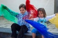 Brother and sister play with silk scarfs