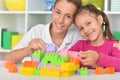 Brother and sister playing with colorful plastic blocks together Royalty Free Stock Photo