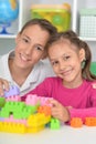 Brother and sister playing with colorful plastic blocks together Royalty Free Stock Photo