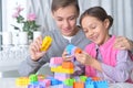 Brother and sister playing with colorful plastic blocks Royalty Free Stock Photo