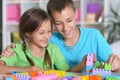 Brother and sister playing with colorful plastic blocks Royalty Free Stock Photo